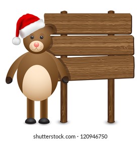 teddy bear in a Santa Claus hat on a wooden background banner