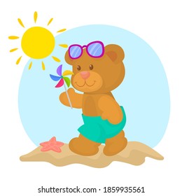 Teddy bear in shorts walking on the beach with toy windmill and sunglasses