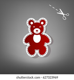 Teddy bear sign illustration. Vector. Red icon with for applique from paper with shadow on gray background with scissors.