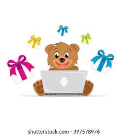 Teddy bear sits in front of a laptop and purchases over the Internet
