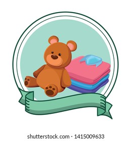 teddy bear toy and folded clothes icon cartoon in round icon with ribbon