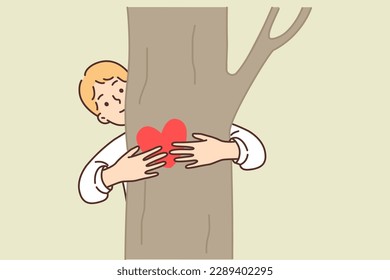 Teen boy hugging tree is sign of love for ecology and concern for environment in need of limiting deforestation. Boy environmental organization volunteer draws attention to problem of CO2 emissions 