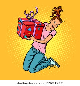 teen girl with a gift jump of joy. Pop art retro vector illustration kitsch vintage drawing