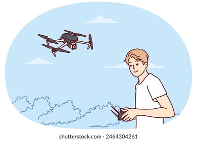 Teenage boy launches quadcopter using remote control and makes aerial photography from drone. Guy has hobby launching miniature aircraft or quadcopter with remote operation wanting to become operator