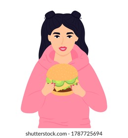 A teenage girl holding a huge burger. Street fast food. Unhealthy eating