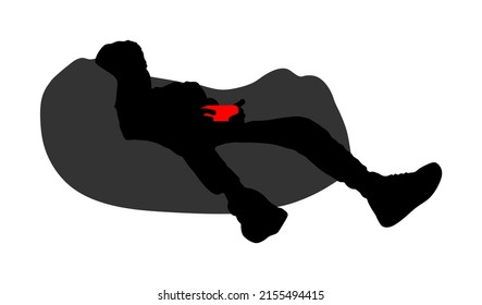Teenager gamer boy playing video game and watching screen monitor vector silhouette illustration isolated on white background. Kid with joystick on lazy bed enjoying. Children entertainment shape. 