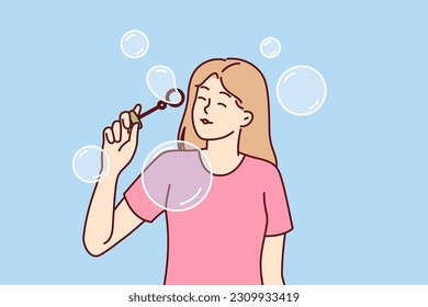 Teenager girl blows soap bubbles enjoying presence free time and absence of urgent matters. Carefree schoolgirl teen stands among soap bubbles and is too lazy to do extracurricular work