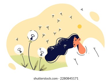 Teenager girl walking in spring meadow blowing dandelions enjoy fresh air and warm weather. Concept summer outdoor recreation with natural flora and dandelions growing in meadow causing allergies 