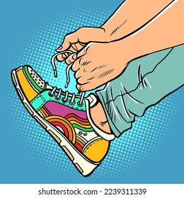 A teenager puts on sneakers, close-up, bright sports youth urban shoes