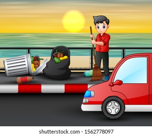 Teenager sweeping the road near the beach