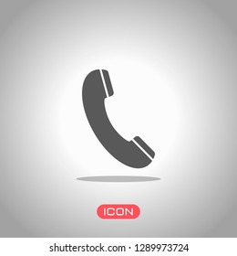 Telephone receiver icon. Icon under spotlight. Gray background