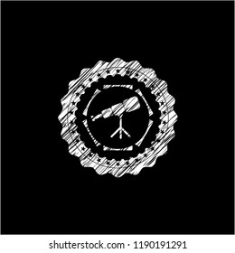 telescope icon inside chalk emblem written on a blackboard