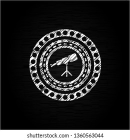 telescope icon inside chalk emblem written on a blackboard