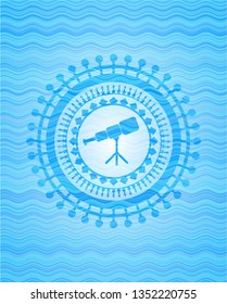 telescope icon inside sky blue water badge.