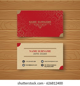 Template of the empty business card on a wooden table. The card with a pattern with a realistic shadow. Vector illustration.