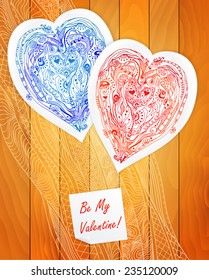 Template frame design element paper heart for love card with doodle lace hearts. Red and blue heart pattern on wood background. Can be used for packaging, invitations and template.