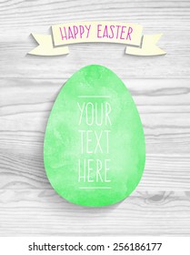 template greeting card Happy Easter with green watercolor egg with shadow on a wooden background