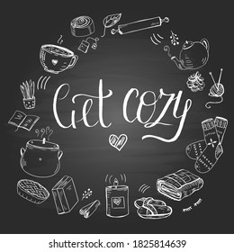 Template with hand drawn elements and text Get Cozy. Christmas wreath with winter hygge symbols: candles, tea, socks and other