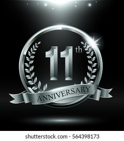 Template silver logo 11th anniversary with ring and laurel branches on dark background