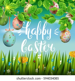 Template vector card with realistic colorful eggs, grass and flowers. Handwriting inscription Happy Easter. Sunny green background. Foliage. Lettering, calligraphy. 3D. Decorated eggs hang on a tree.