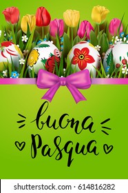 Template vector card with realistic colorful decorated eggs, grass, and tulips. Handwritten Italian inscription Happy Easter. Bright green background. Ribbon and bow. Brush lettering.