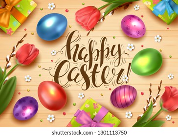 Template vector card with realistic eggs, gift box and flowers. Handwriting inscription Happy Easter. Colorful shiny 3D eggs. Wood background. Willow branches and tulips. Lettering, calligraphy.