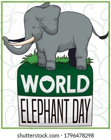 Tender big elephant, standing over a green calendar with reminder for World Elephant Day celebration, decorated with shield and floral design in the background.