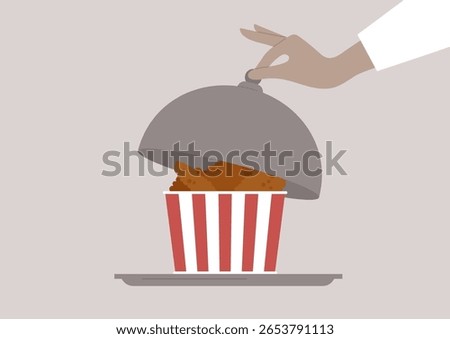 Tender and crispy chicken wings are presented in a striped container, enticing diners with their golden-brown colo, A hand lifts the dome, revealing this savory delight