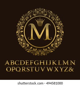 Tendrils gold letters with M initial monogram. Baroque style font for logo design. Isolated english vintage alphabet.