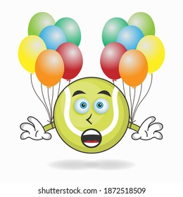 Tennis ball mascot character holding a balloon. vector illustration