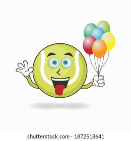 Tennis ball mascot character holding a balloon. vector illustration