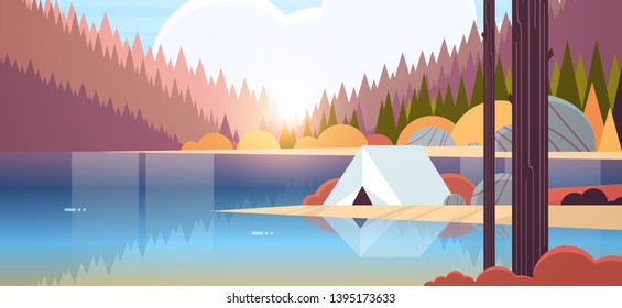 tent camping area in forest campsite near river autumn camp travel vacation concept sunrise landscape nature background with water mountains and hills flat horizontal