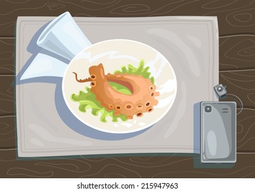 Tentacle octopus grilled in a circular plate on a wooden table, lies next to a mobile phone