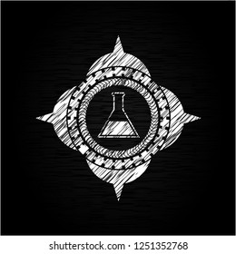 test tube icon inside chalk emblem written on a blackboard