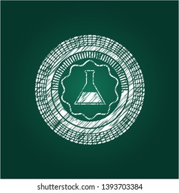 test tube icon inside chalk emblem written on a blackboard