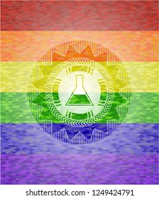 test tube icon inside emblem on mosaic background with the colors of the LGBT flag