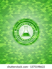 test tube icon inside green emblem with mosaic background