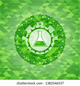 test tube icon inside green emblem with mosaic ecological style background