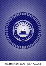 test tube icon inside jean or denim emblem or badge background
