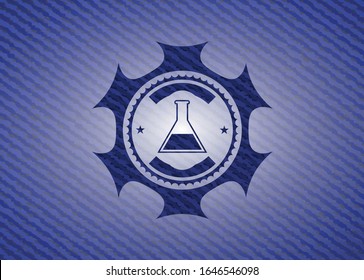 test tube icon inside jean or denim emblem or badge background