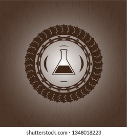 test tube icon inside wooden emblem. Vintage.