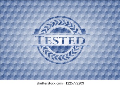 Tested blue badge with geometric pattern background.