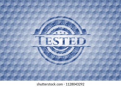 Tested blue emblem or badge with abstract geometric pattern background.