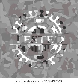 Tested written on a grey camouflage texture