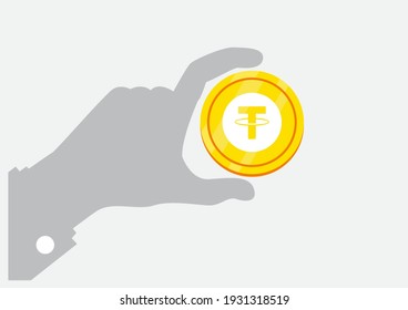 Tether (USDT) und Crypto Currency Concept - Hand, die goldene Münze hält - digitales Zahlungssystem