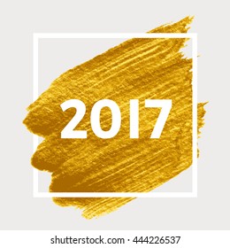 Text 2017. Happy New Year. Golden brush stroke in white square.