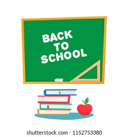 the text back to school on the green board. red apple and pile of books