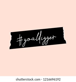 Text #goaldigger in white written on a black washi tape, isolated on pastel pink background. Inspirational square wall art, social media post, greeting card, t-shirt design.