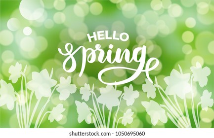 “Hello spring” text inscription. Typography, lettering, calligraphy for greeting card, poster, flyer, banner on green light bokeh blurred background with flowers, vector illustration.