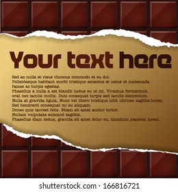 Text on golden paper under scraped chocolate
